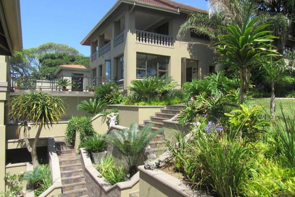 A paved driveway leads to this spectacular multi-level home. Set in tropical ...