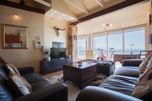 As you enter the apartment you note the beach immediately outside, with no intervening ...