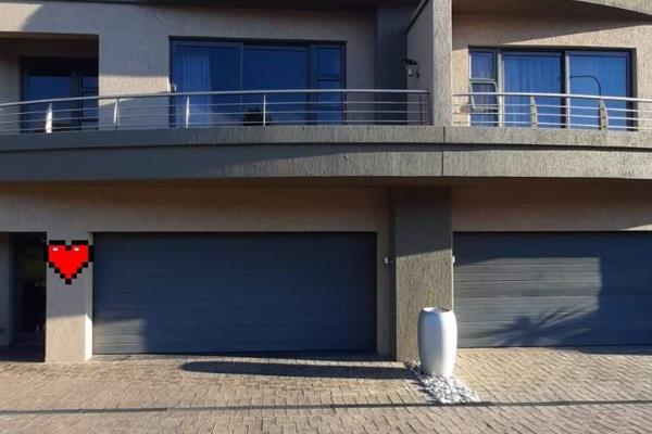 Stunning townhouse for saleon the Golf Estate.

Open plan dining and living room with a bar.
Open plan kitchen.
This space also leads ...