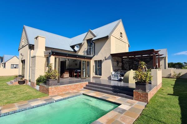 Step into sunlit elegance in this inviting, double storey home in this secure Estate ...