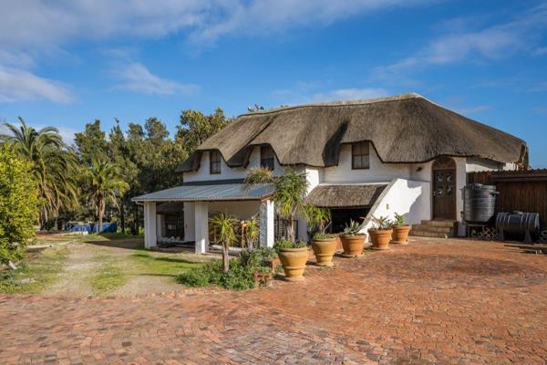 This stately thatched residence comes with a main house, 2 cottages and a large open plan room currently being used as a gym. 

In the ...