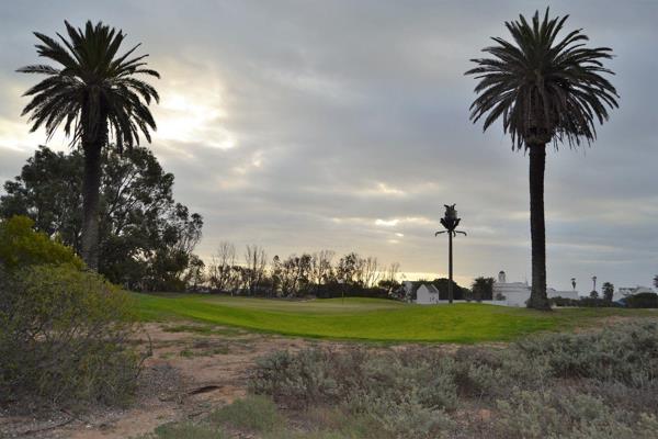 This north facing plot borders on to the beautiful third green which is surrounded by palm trees.  You could stand on your patio a chip ...