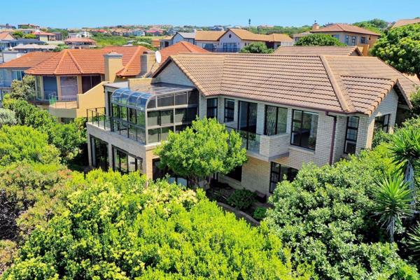 Positioned on the water&#39;s edge, this well-built modern face brick home offers ...