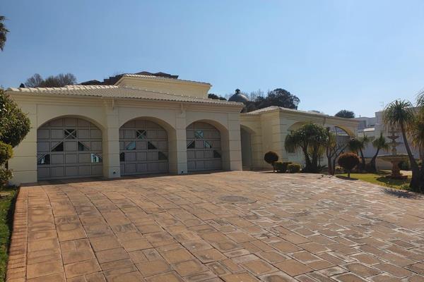 With its cool, cream-colored walls, white aluminium window frames and stainless-steel finish garages, this single story home, situated ...