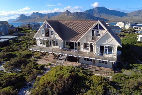 This ocean front wooden beach-style home is a perfect place to replenish your soul with ...