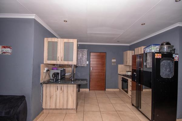 Welcome to this inviting and cozy home that boasts a spacious open-plan kitchen complete with ample cupboard space. The kitchen flows ...