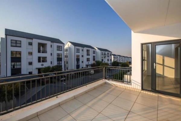 The open plan kitchen overlooks a spacious living room area, big enough to fit a lounge ...