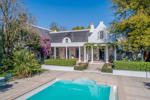 This elegant Cape Dutch home is surrounded by a forest of mature stinkwood trees, and ...