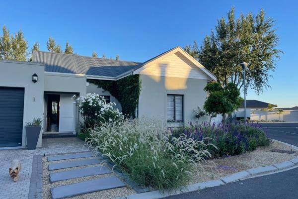 This modern home offers a seamless flow of living spaces, featuring and open-plan ...