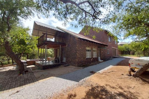 This beautifully tucked away property is just a stone&#39;s throw from the Crocodile River. It&#39;s situated on a large panhandle ...