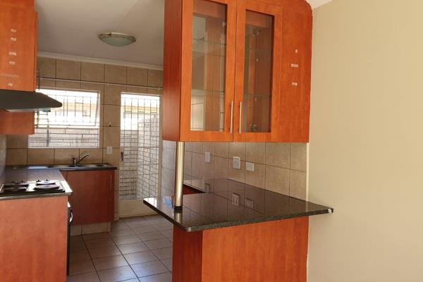 This property has lovely &quot;cherry wood&quot; kitchen cupboards with glass display ...