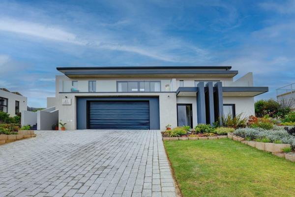 The top level of the home lends itself freely to an open-plan living room, lounge, and ...