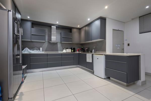 This exquisite apartment boasts an open plan kitchen seamlessly integrated with a fitted ...