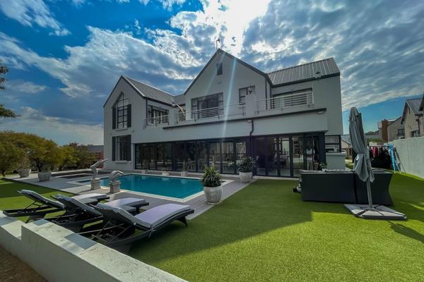 Welcome to this exquisite modern 4-bedroom house in a beautiful farm estate, a true gem of luxury real estate. With its seamless ...