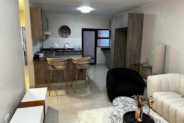 This Apartment opens out onto a covered patio with Built In Braai - perfect for ...