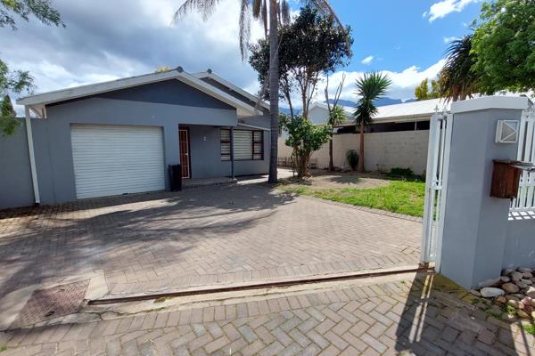 Open plan lounge, dining room with built-in braai and kitchen. Kitchen with built-in ...