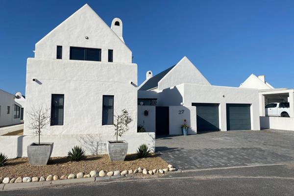 Modern 4 bedroom house for sale in Kersbosstrand walking distance from the ocean.

You enter this upmarket house through a court yard ...