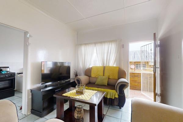 The stunning flat features a beautiful kitchen with white cupboards and a gas stove. The ...