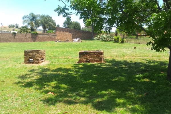 Vacant land with lots and lots of fruit trees. Borehole on the premises.