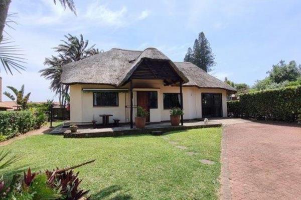 Experience the allure of coastal living in this charming 2-bedroom, 2-bathroom thatched-roof home nestled within a secure complex ...