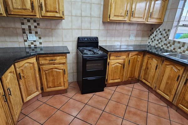 This spacious unit comprises of a compact wood finish kitchen with granite tops and a ...