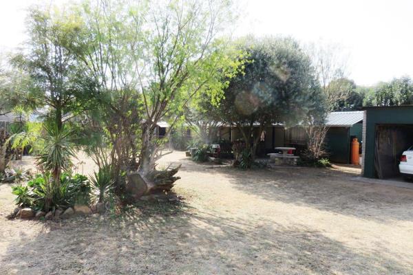 One road from the Vaal Dam in a quiet tree-lined street &amp; tucked away into a private garden is this rough diamond just needing a ...