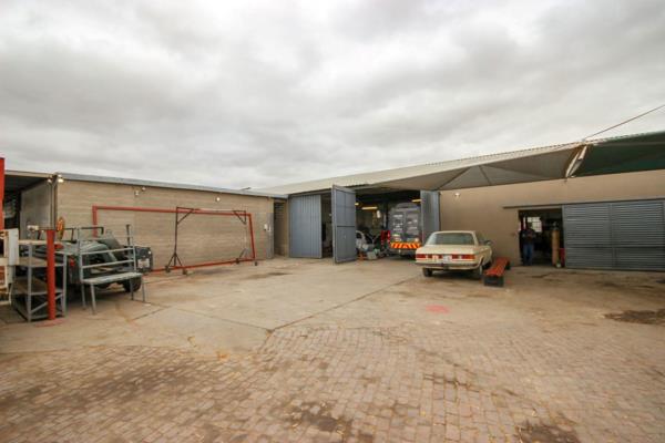 The property is situated between two busy roads in the industrial area of Oudtshoorn. 
The main building includes:
* four workshop ...