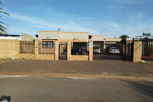 This beautiful face brick home in Lenasia Ext.3 boasts a secure gated community ...