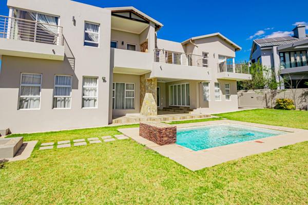 This magnificent home is situated in the secure and upmarket Helderfontein Estate.

An impressive double volume entrance hall greets ...