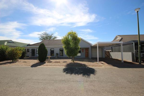 This property is situated in a highly sought-after gated community in Oudtshoorn.

The house boasts an open-plan living room and ...