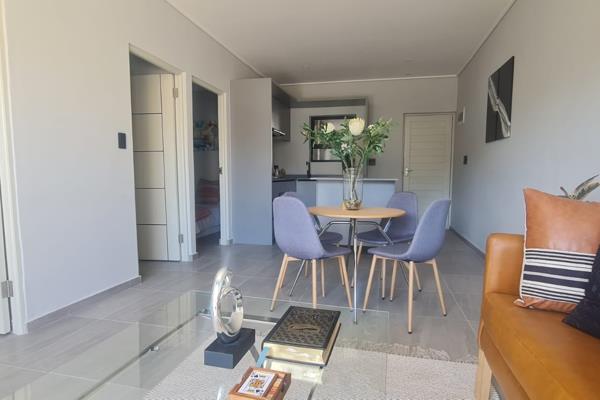 This spacious 2 bedroom 1 bathroom apartment in South Road Table View features modern ...