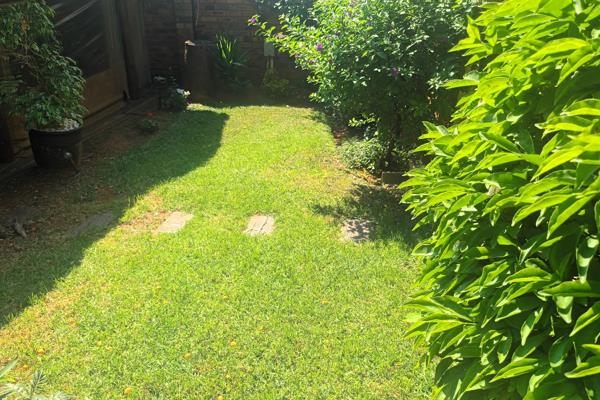 This corner unit offers a cosy private garden with lapa and built-in braai and bar ...