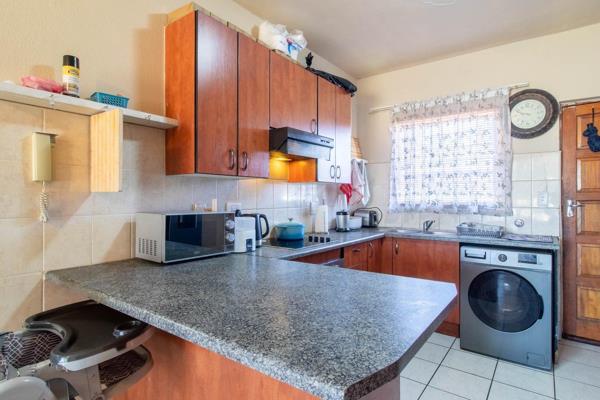 Access is secured with electric gates leading to a designated carport. 
The apartment boasts a spacious kitchen, accommodating a ...