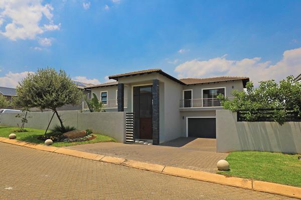 A stunning home featuring a modern kitchen with ceasar stone counter tops, smeg gas hob and scullery.  The kitchen over looks the ...