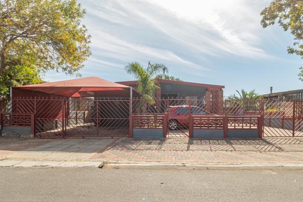 This 3-bedroom property boasts an inviting tiled open plan lounge which features a cozy ...