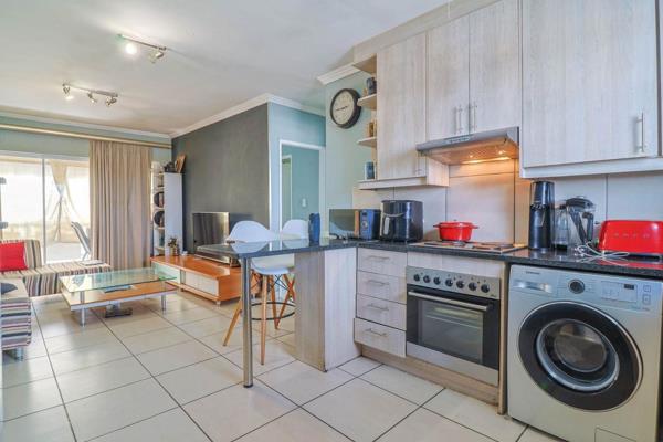 View by Appointment: The apartment features an open-plan&#160;kitchen with contemporary countertops, under-counter stove, double sink ...