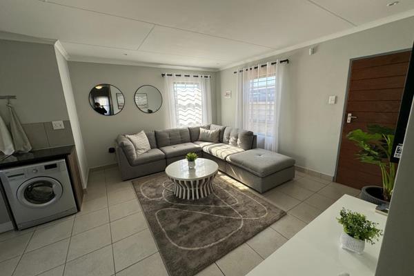 This three-bedroom house in a secure estate offers spacious and modern living. It ...