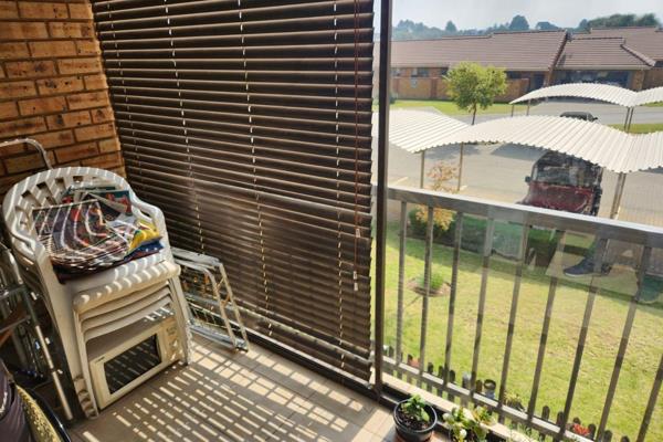 Tiled open plan lounge and dining-room with sliding doors leading to a covered private verandah overlooking the estate

Modern ...