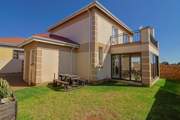 Entrance with security gate! Tiled lounge with gas fireplace and dining room with sliders to covered tiled entertainment patio with ...