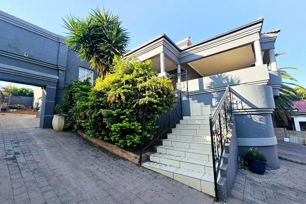 Double garage 
Automated gate 

Study area has tiled floors and built in cupboards 

Tiled stairs leading up into the open plan ...