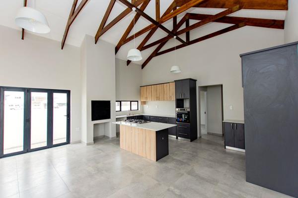 Upon entering, you are greeted with a spacious interior featuring tiled floors throughout, providing a cool and easy-to-maintain living space. The open-plan layout seamlessly connects the living, dining, braai and kitchen areas ...