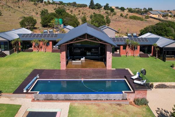 Discover an executive entertainer&#39;s paradise in this completely off-the-grid modern mansion. Boasting a spacious double-volume ...