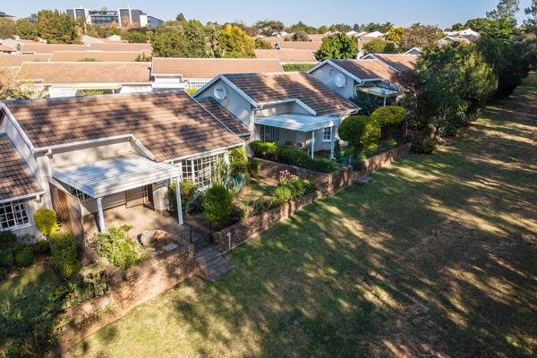 This spacious home offers an open-plan lounge and dining room that opens up onto a covered patio with a private garden.

The kitchen ...