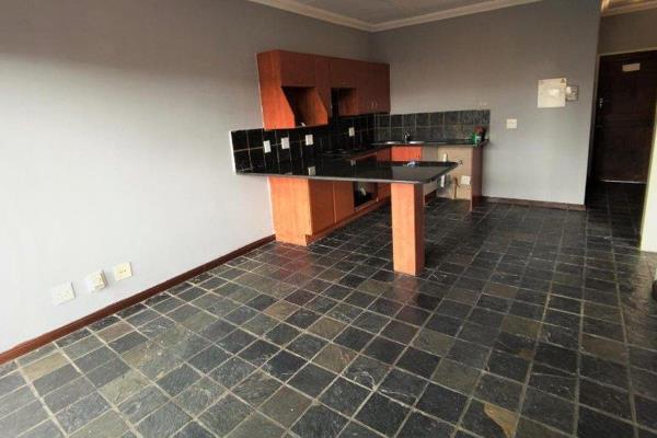 The kitchen has ample built in cupboard space, an oven, stove, space for an under ...