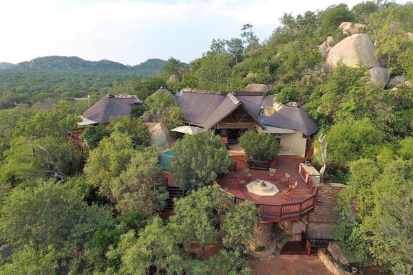 Spectacular bush home, nestled into a granite rocky outcrop, by well-known Architect Henk Schmidt. This home has been designed to make ...