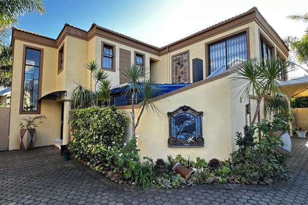 Elegant Tuscan-style designed home with warm, earthy colours with decorative brick an tile accents.  The paving around the house allows ...