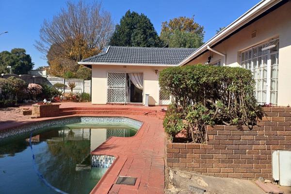 This charming granny flat features a tiled bedroom, a bathroom with a shower, and a ...