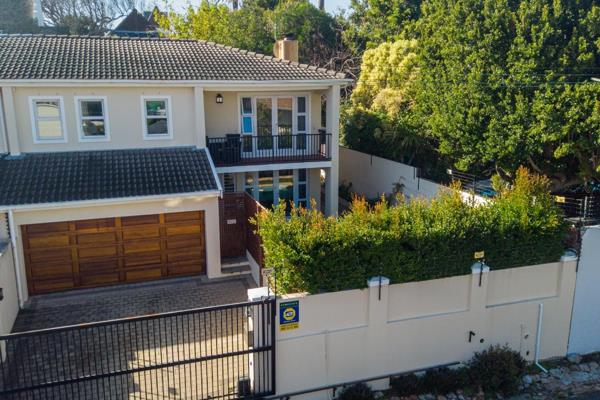 This charming three-bedroom double-story home in upper Wynberg boasts elegant finishes ...