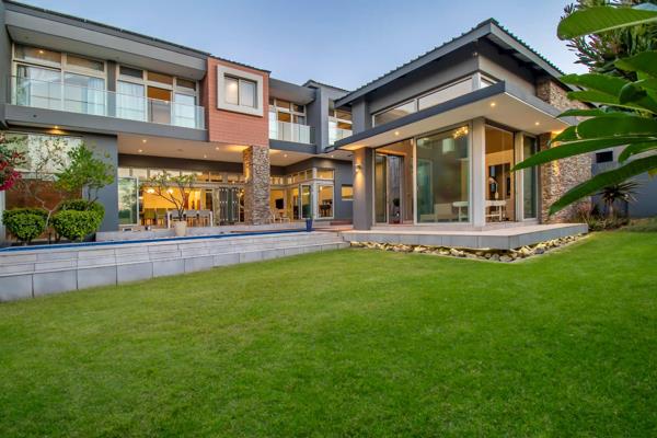 The stunning double volume entrance of this house is a prelude of what the rest of the home  has to offer. The spectacular glass front ...