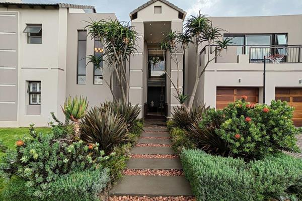 This modern abode has been built with family and entertainment in mind. The entrance crosses over a koi pond into a double volume ...